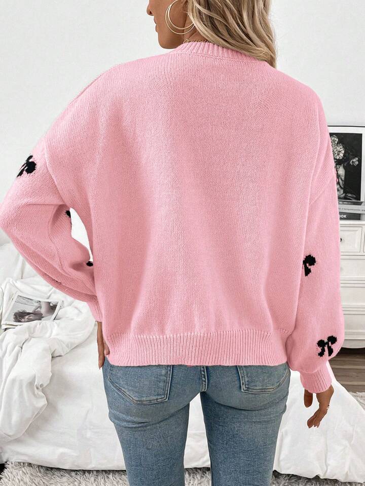 Pink Knit Sweater with Black Bow Pattern – Cozy Oversized Pullover